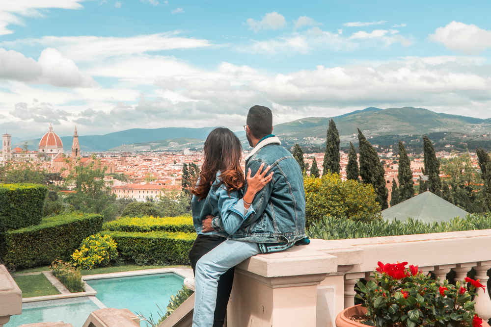Couple enjoying scenic view of Florence Italy honeymoon with iconic city skyline and hills in the background