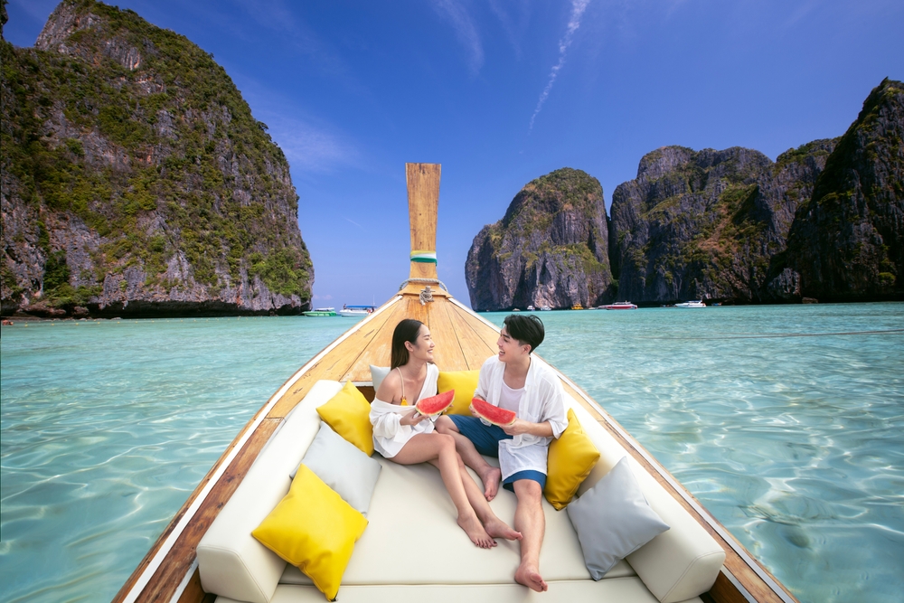 Couple enjoying a romantic boat trip and fresh fruit during their Koh Samui honeymoon