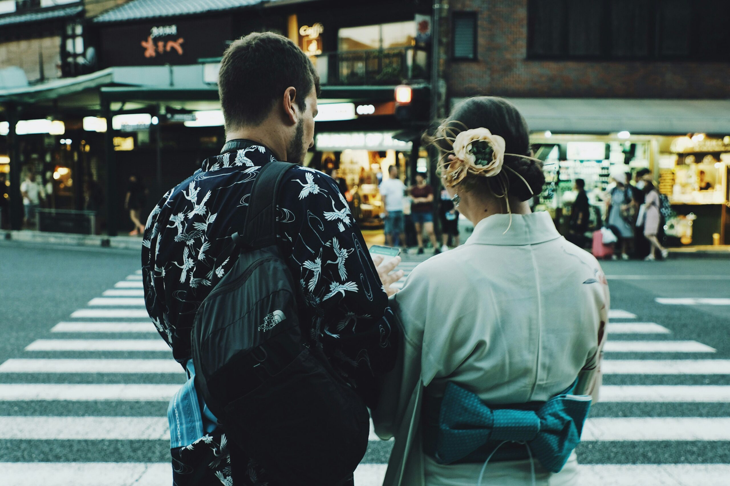 Couple wearing traditional Japanese kimonos exploring city streets during their Tokyo honeymoon.