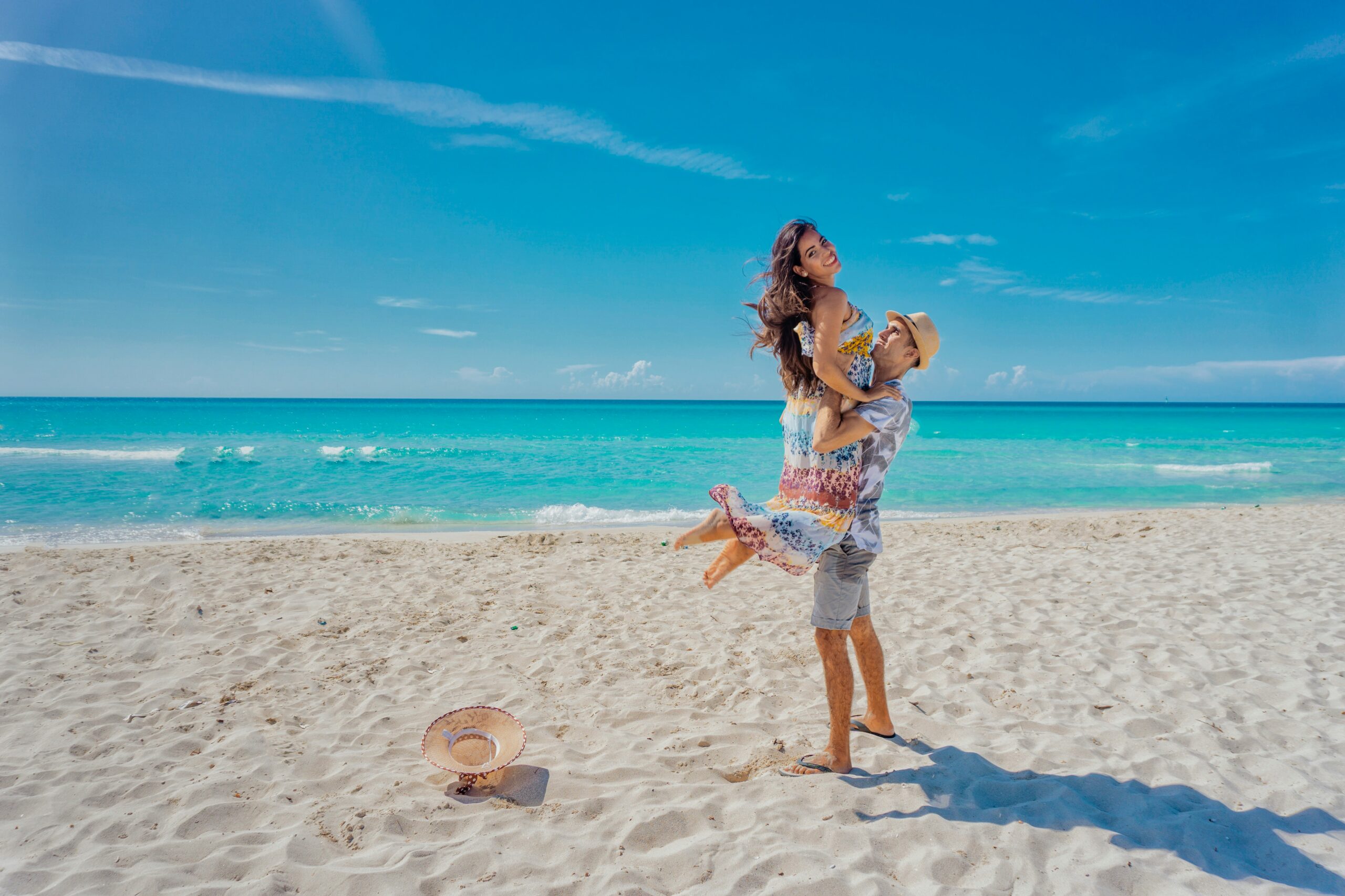 Romantic couple having fun on the beach enjoying maldives honeymoon travel packages