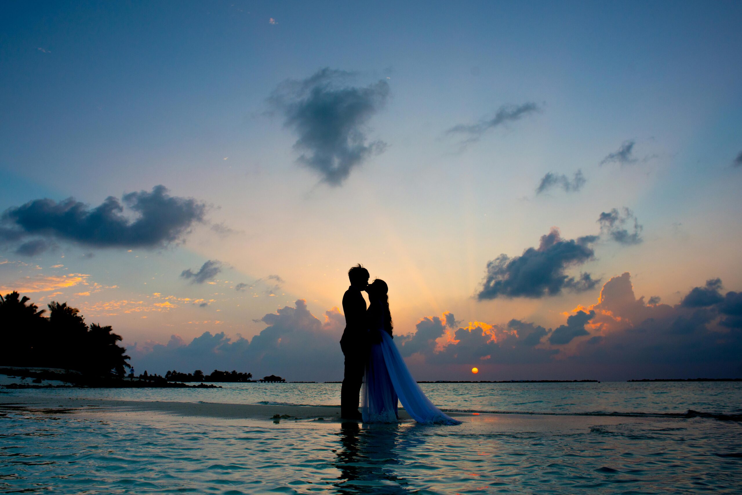 Romantic couple at sunset on a beach enjoying their luxury mauritius honeymoon package