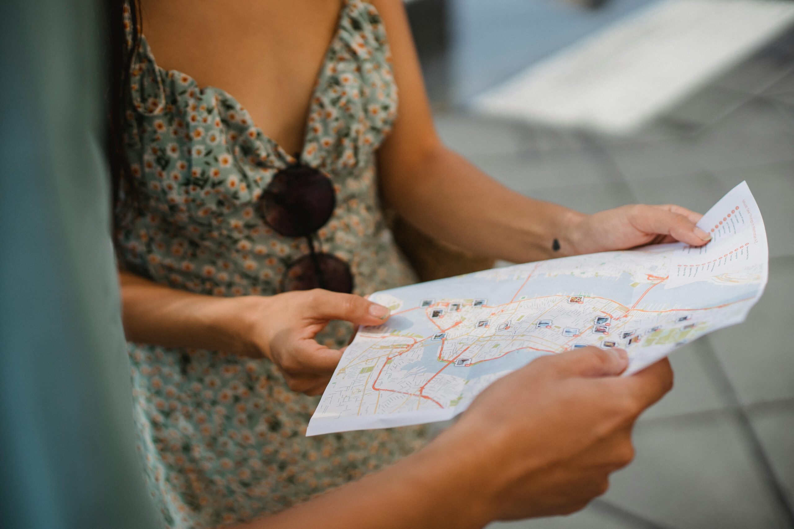 A close-up of a couple's hands holding a travel map to find the best India honeymoon locations.