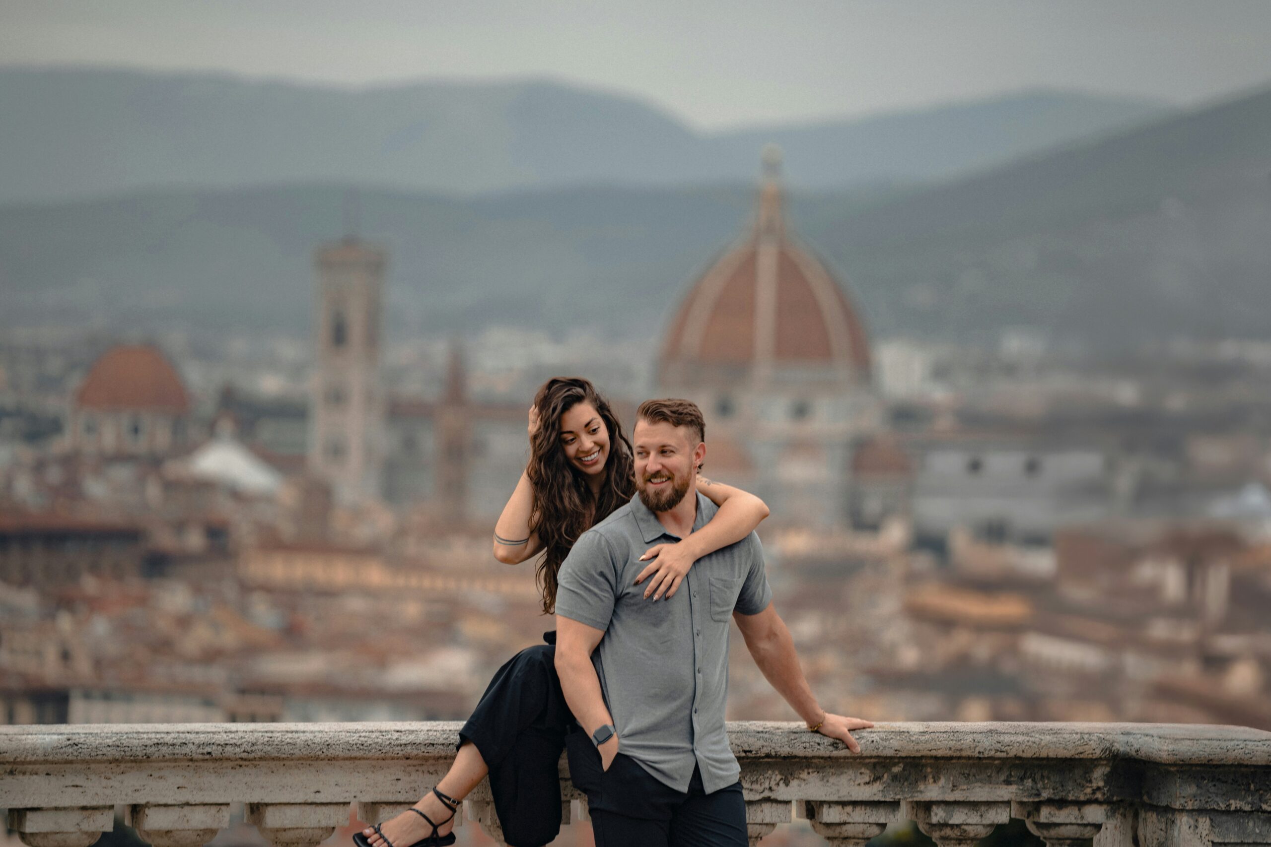 Happy couple with Florence cityscape in the background during a Florence Italy honeymoon ideal for Italy honeymoon packages